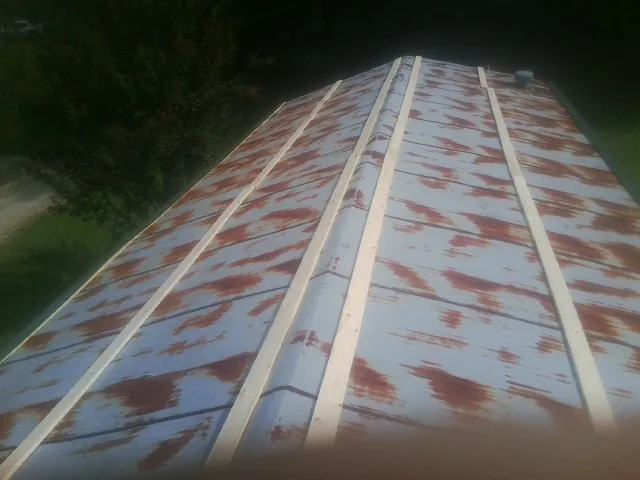 Rusted metal roof panels with new wood purlins before replacement — Storm Damage Roof Repair in Adairsville by Roofing Brothers