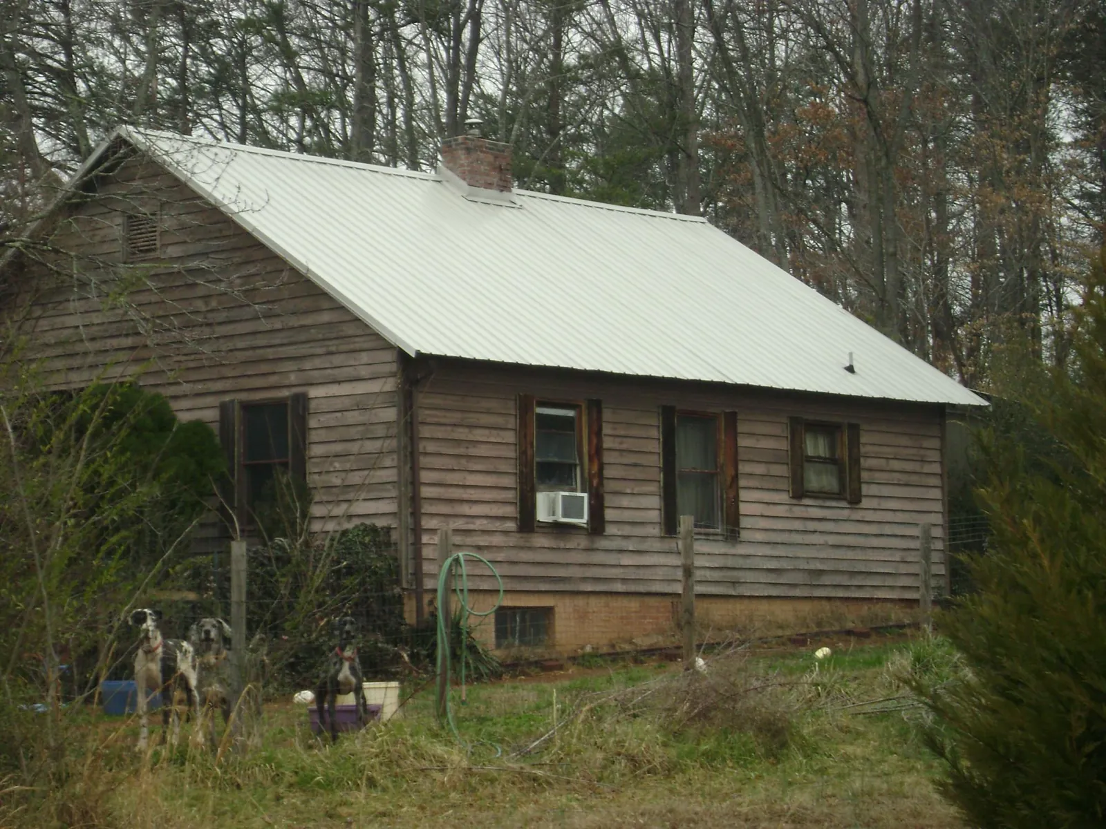 White metal roof on an old wood sided farmhouse, from a Asphalt Shingle Roof Repair job in Adairsville
